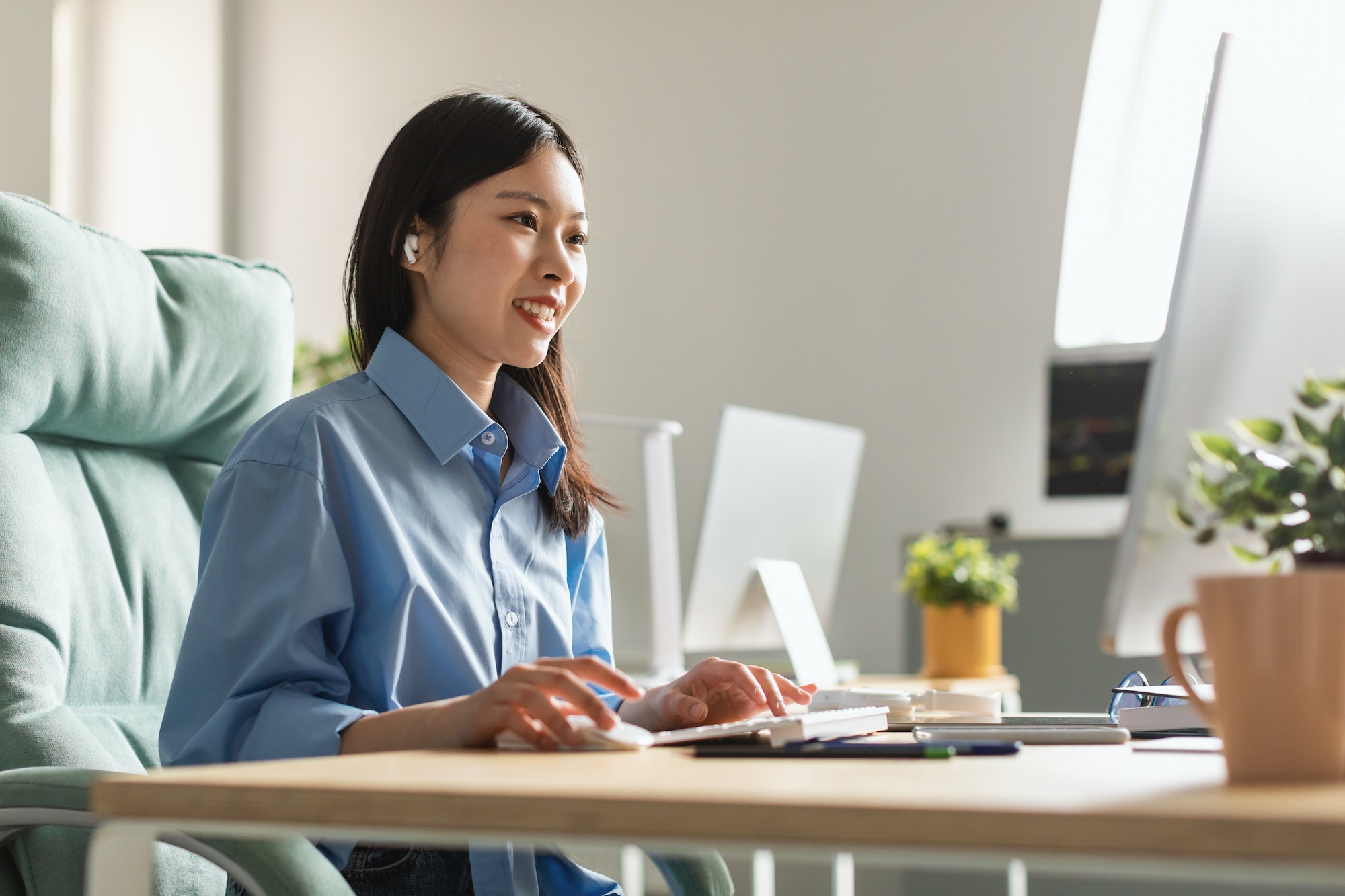 Happy Asian Millennial Businesswoman Working Online On Computer In Office